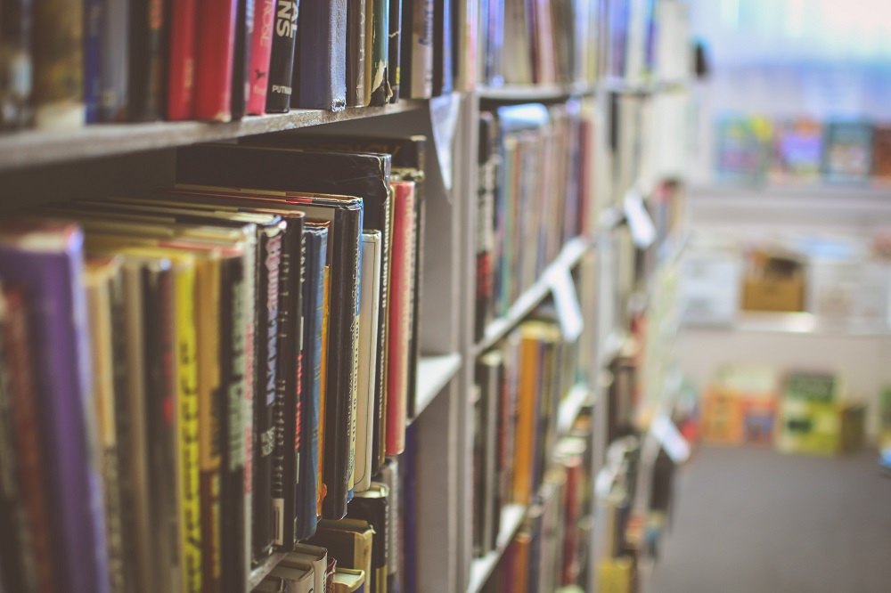 Books organised in a shelf by Jamie Taylor on Unsplash