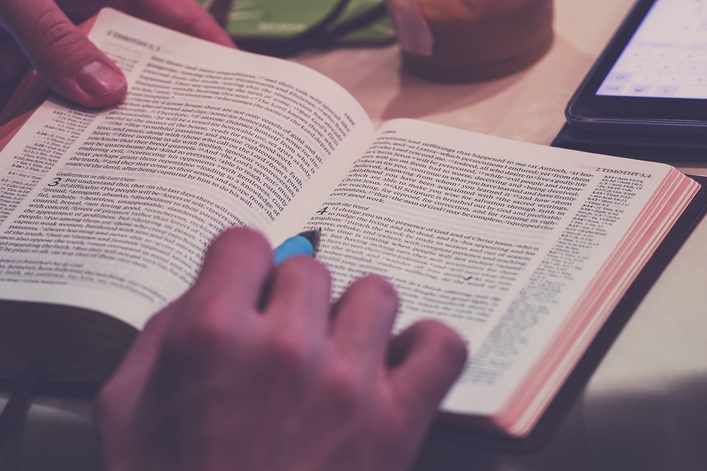 Person holding pencil near laptop computer by Scott Graham on Unsplash